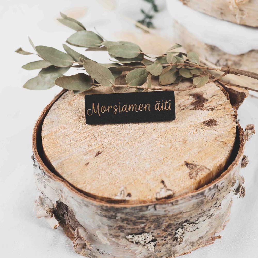 Musta puinen paikkakyltti tekstillä morsiamen äiti.