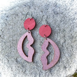 Korvakorut, joissa punainen pallo, josta roikkuu vaaleanpunaiset huulet.